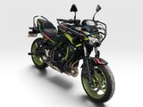 a black and green motorcycle parked on a white surface