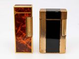 two lighters are sitting next to each other on a white surface