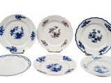 six pieces of blue and white plates with flowers on them