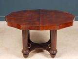 an oval mahogany dining table with two leaves on the top