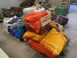 a pile of bags and a cart in a warehouse