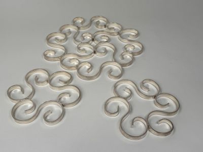 several pieces of white plastic on a white surface