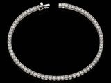 a diamond tennis bracelet on a black background