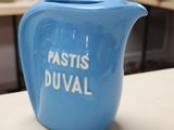 a blue pitcher sitting on a counter in a store