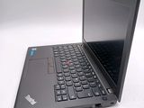 a black laptop computer sitting on a white surface