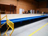 a large flat bed in the middle of a warehouse