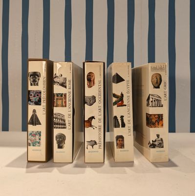 five books that are lined up on a table