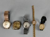 several different types of watches are displayed on a white surface