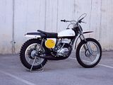 a white and yellow motorcycle parked in a parking lot