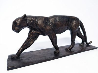 bronze statue of a panther on a marble base