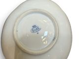 a white bowl with a blue and white design on it