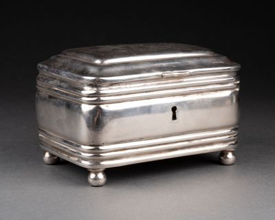 a silver box with a key on it on a table