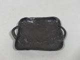 a black tray with a handle on a white surface