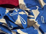 a close up of a blue and white cloth with a red and white design