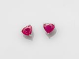a pair of pink heart shaped earrings on a white background