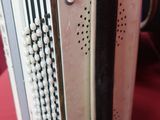 a small white accordion sitting on a red table