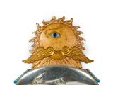 a gold and silver brooch with a blue eye on it