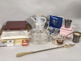 a lot of silver and glass items on a table