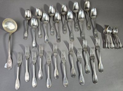 a lot of silver spoons and forks laid out on a table
