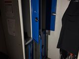 two blue lockers in the corner of a room