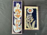 two boxes that have flowers on them on a table