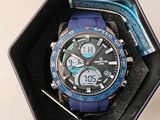 a watch that is in a box with a pen in it