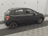 a picture of a small black car parked in a garage