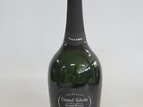 a bottle of champagne sitting on a white surface