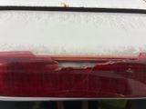 a close up of a car ' s tail light with a lot of snow on it
