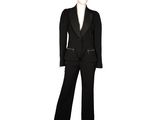 the woman is wearing a black suit and pants with a white shirt