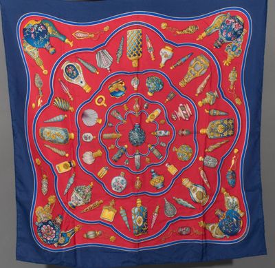 an image of a red and blue scarf with various items on it