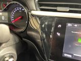 a car dashboard with a digital display and a steering wheel