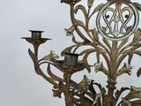 a large metal candelier with a bird on top of it