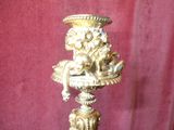 a gold vase with a statue on top of it