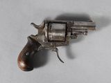 a small revolver with a wooden handle on a table