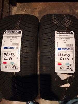 two tires on the ground with a person standing next to them