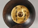 a close up of a wooden object with writing on it