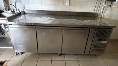 a stainless steel counter in a kitchen with a sink