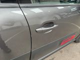 the door of a gray car with a red stripe on the side of it