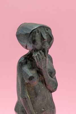 an image of a statue of a woman with a hat on her head