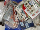 a pile of stamps and envelopes sitting on a table