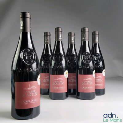 six bottles of wine are lined up in a row on a table