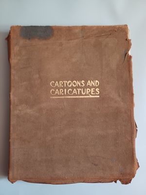 an old book sitting on top of a table next to a cup of coffee