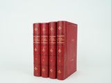 three red books sitting on top of each other on a white surface