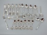 a lot of silver spoons and forks on the table