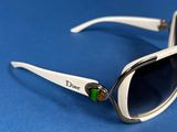 a close up of a pair of sunglasses on a blue surface