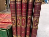 several books are stacked on top of each other on a table