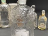 a bottle of perfume sitting on a table next to other bottles