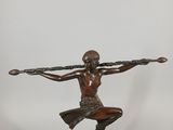 bronze statue of a man holding a spear on a marble base
