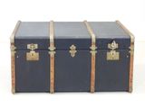 a black trunk with two gold handles and a black top